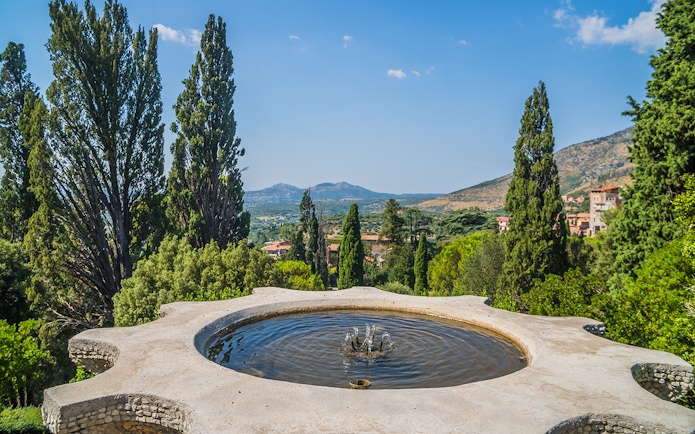 Fountain with scenic view of gardens and hills at Villa d’Este, Italy.