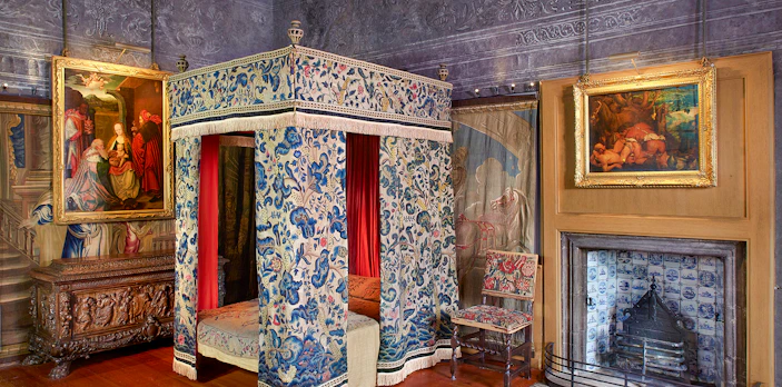 Mary Queen of Scots Bedchamber with ornate canopy bed and paintings at the Palace of Holyroodhouse.