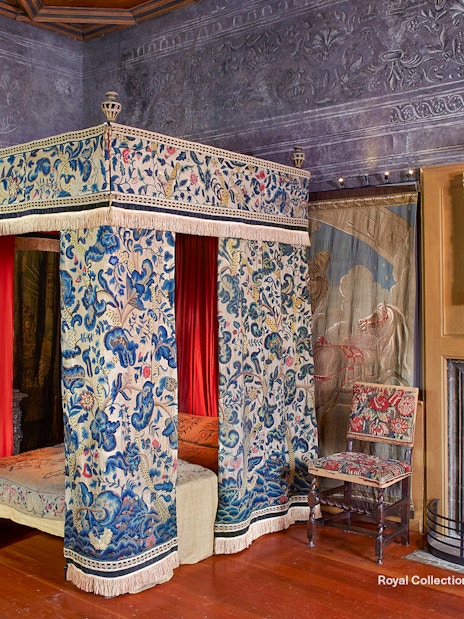 Mary Queen of Scots Bedchamber with ornate canopy bed and paintings at the Palace of Holyroodhouse.