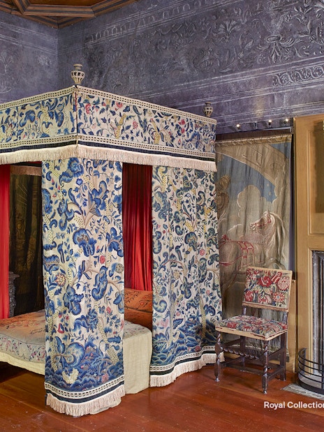 Mary Queen of Scots Bedchamber with ornate canopy bed and paintings at the Palace of Holyroodhouse.
