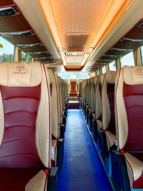 Interior of a tour bus with comfortable seating for Aquaventure Waterpark visitors.