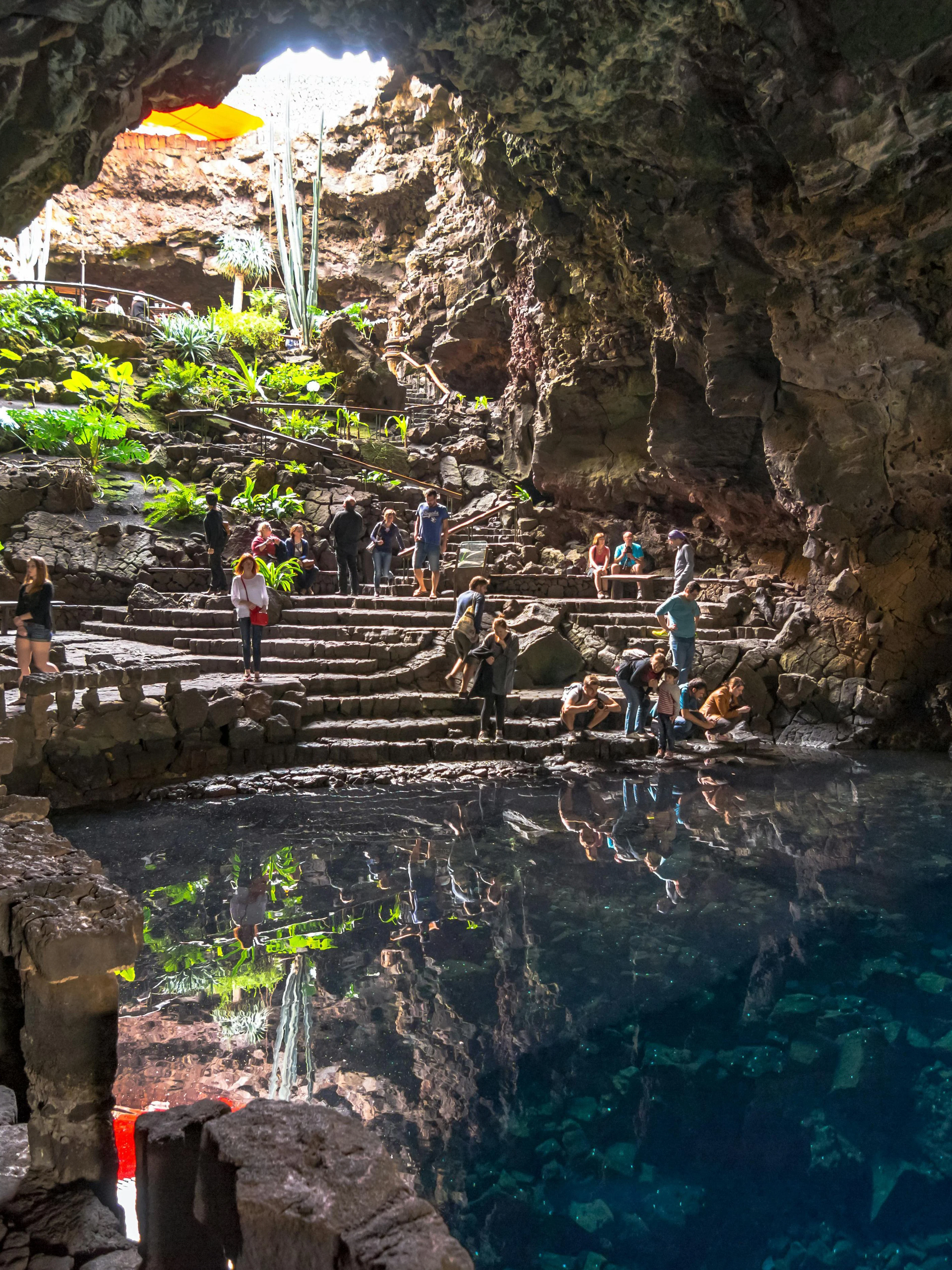 Visitors exploring Jameos del Agua cave and lake in Lanzarote, Canary Islands.