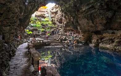 Visitors exploring Jameos del Agua cave and lake in Lanzarote, Canary Islands.