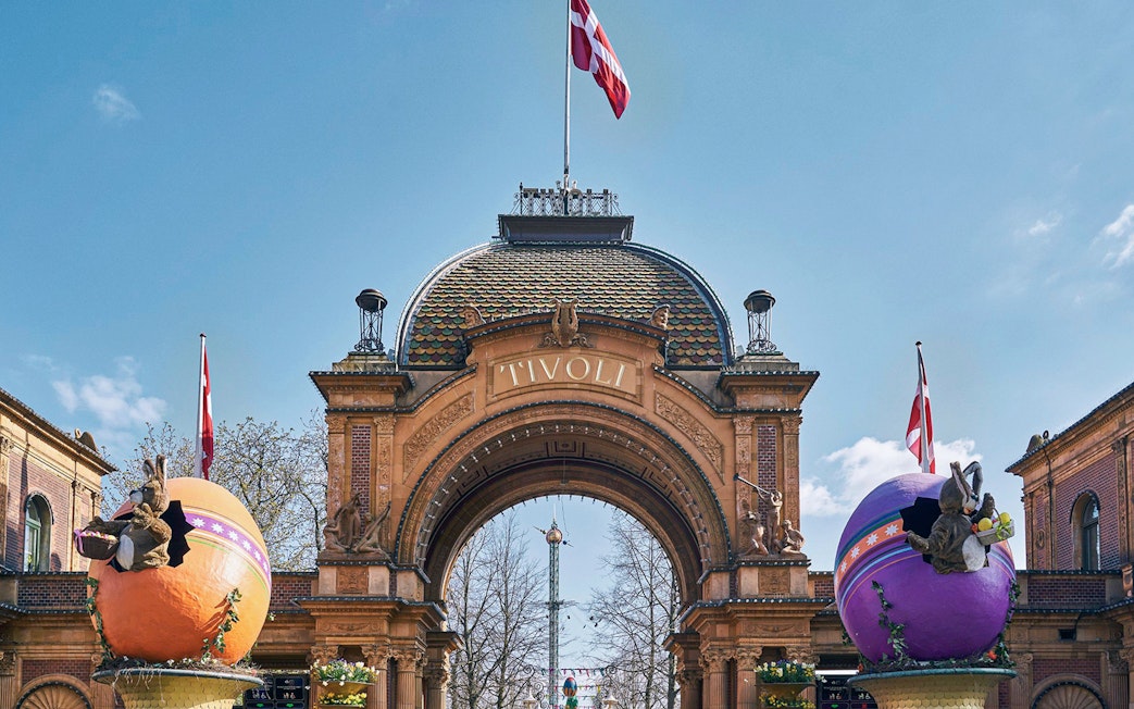 Tivoli Gardens entrance with decorative eggs and Danish flags in Copenhagen.