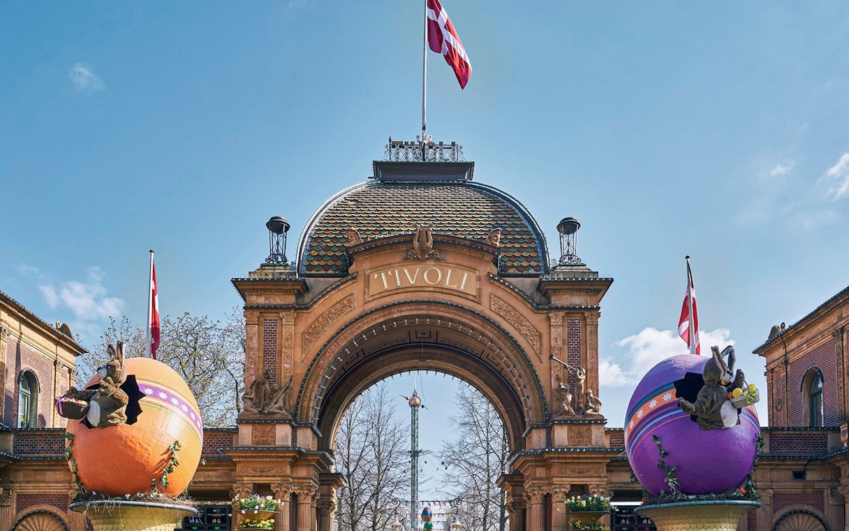 Tivoli Gardens entrance with decorative eggs and Danish flags in Copenhagen.