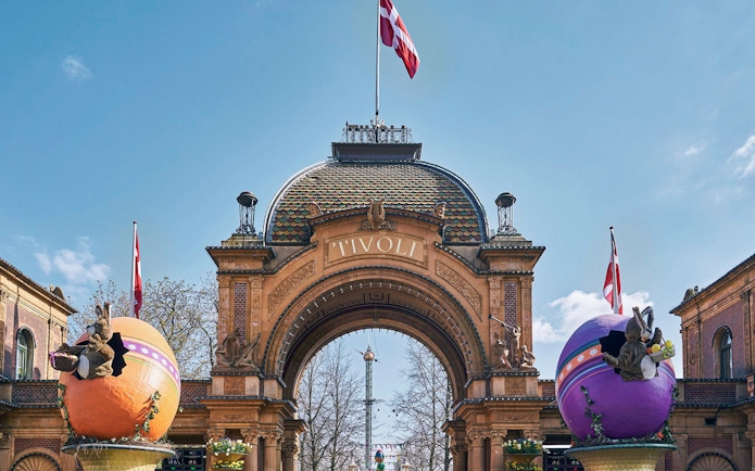 Tivoli Gardens entrance with decorative eggs and Danish flags in Copenhagen.