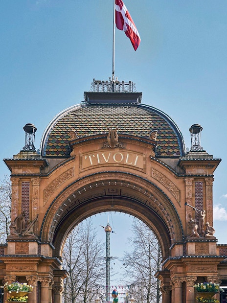 Tivoli Gardens entrance with decorative eggs and Danish flags in Copenhagen.