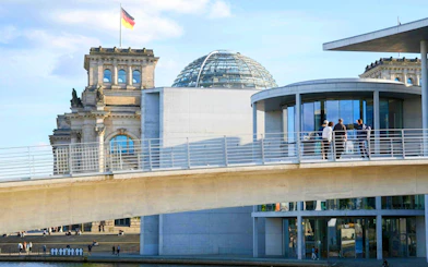 Guided tour group on a bridge near the Reichstag Dome in Berlin's Government District.