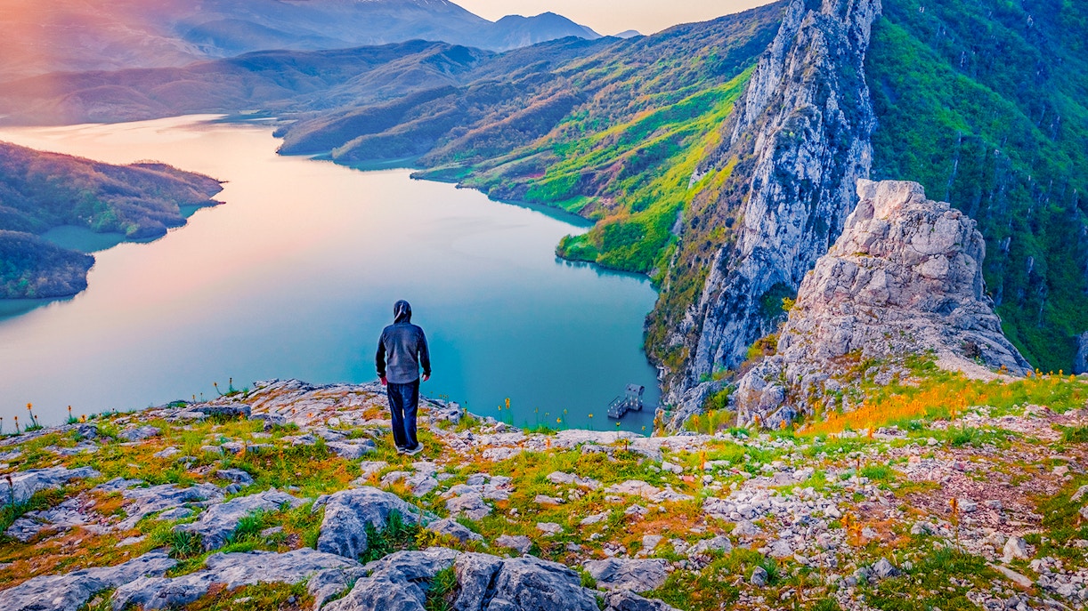 Hiker overlooking Bovilla Lake from Gamti Mountain during private tour.