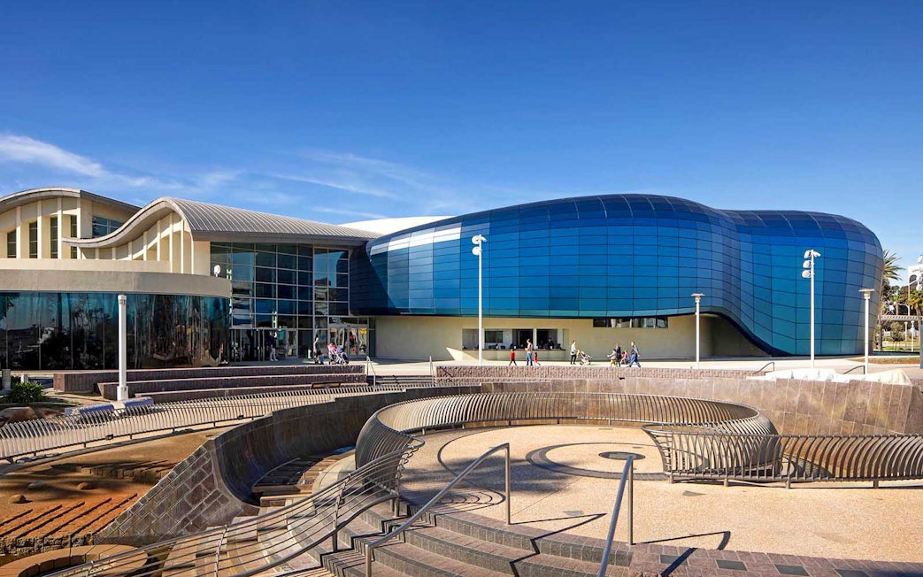 Aquarium of the Pacific entrance with visitors entering, Long Beach, California.