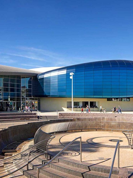 Aquarium of the Pacific entrance with visitors entering, Long Beach, California.