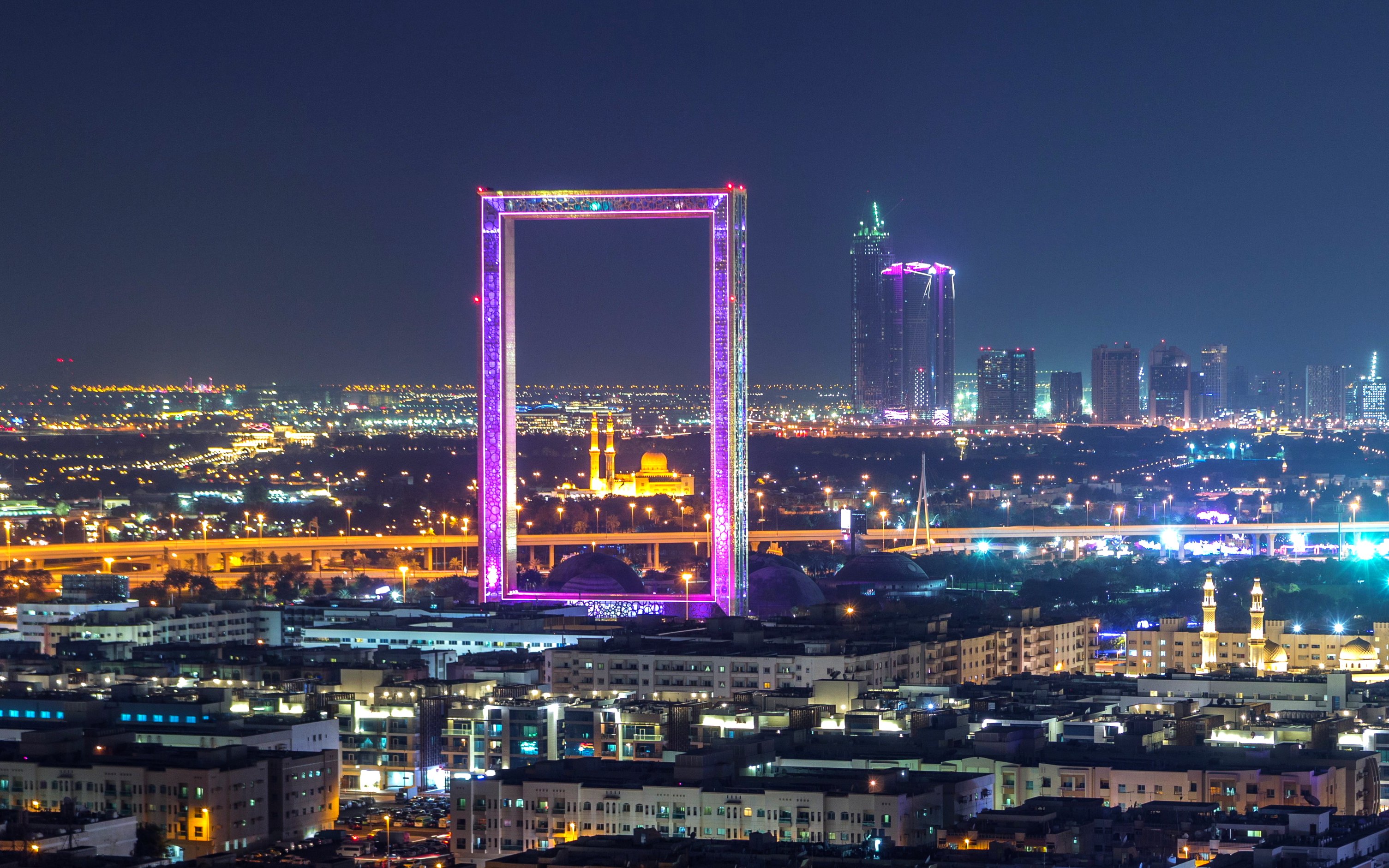 Dubai Frame with Zabeel Masjid mosque illuminated at night.