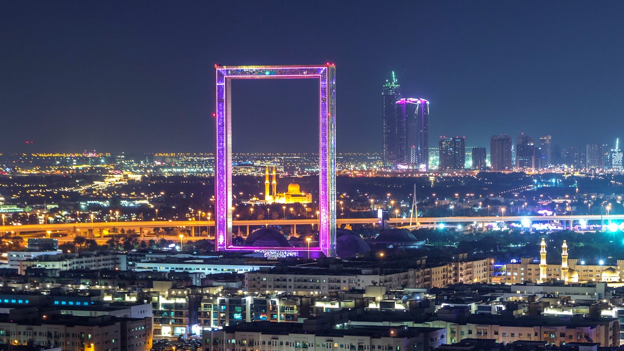 Dubai Frame with Zabeel Masjid mosque illuminated at night.