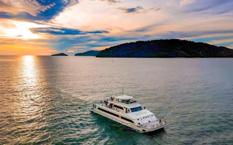 Cruise ship on the water at sunset near islands, North Borneo Cruises, Kota Kinabalu.