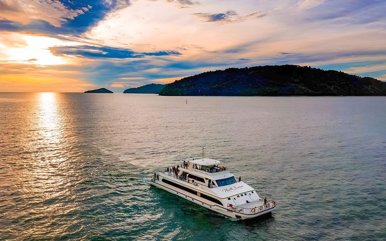 Cruise ship on the water at sunset near islands, North Borneo Cruises, Kota Kinabalu.
