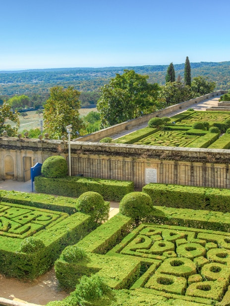 Gardens of the Royal Seat of San Lorenzo de El Escorial with manicured hedges near Madrid, Spain.