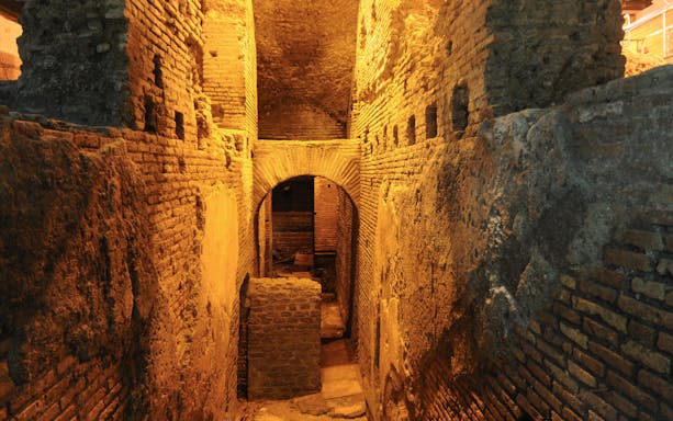 Underground ruins in Navona Square, Rome, showcasing ancient brick architecture.