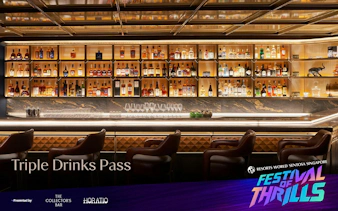 Luxury bar counter with leather stools and back-lit liquor shelves at Resorts World Sentosa Singapore.