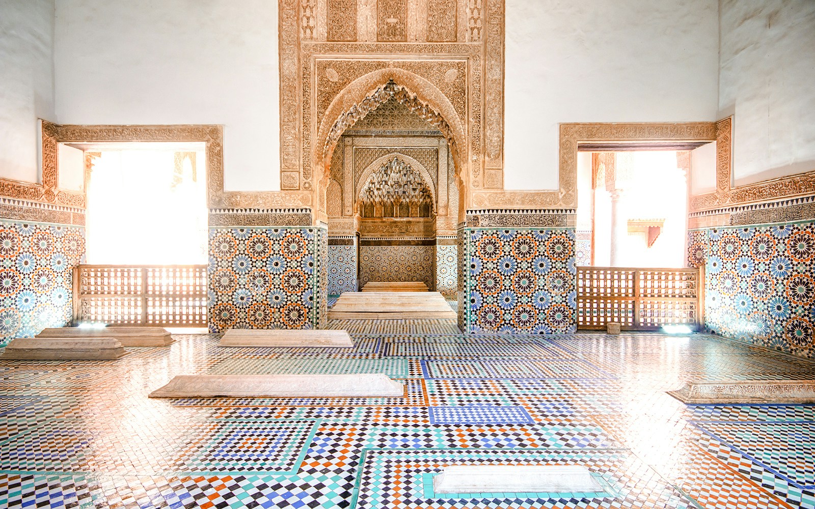 Saadian Tombs interior with intricate mosaic tiles and carved arches, Marrakech.