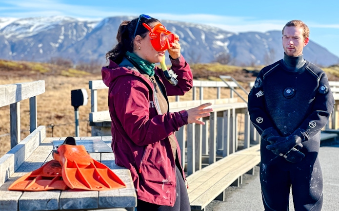 Guest preparing for deepwater snorkeling in Silfra with safety gear.