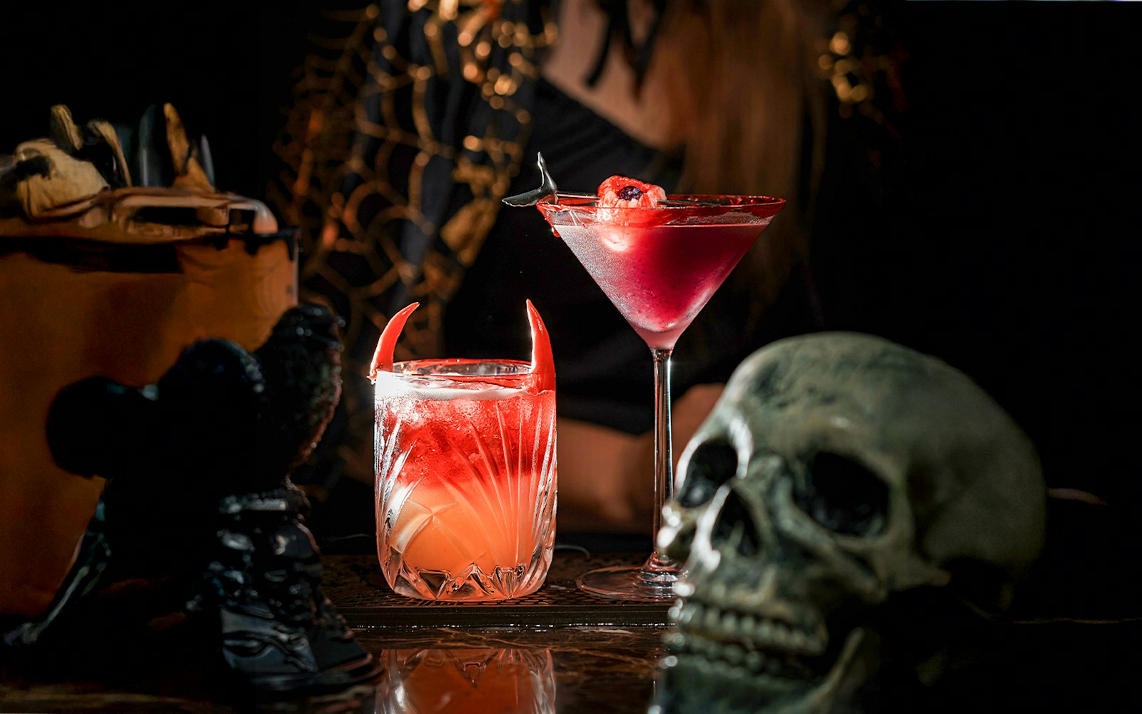 Halloween-themed cocktails with devil horns and skull decoration.