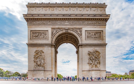 Arc de Triomphe in Paris with tourists and Big Bus in the background.