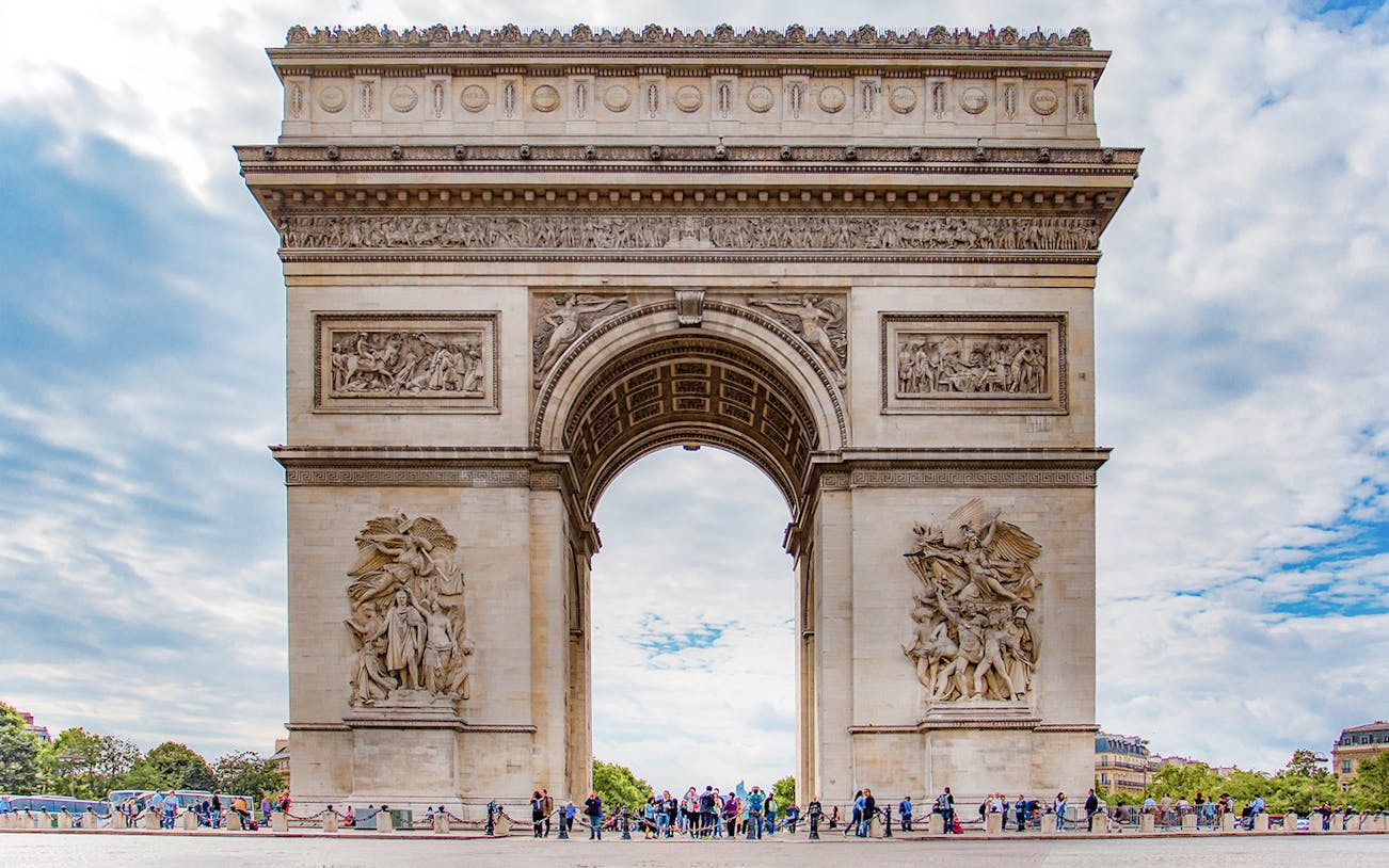 Arc de Triomphe in Paris with tourists and Big Bus in the background.