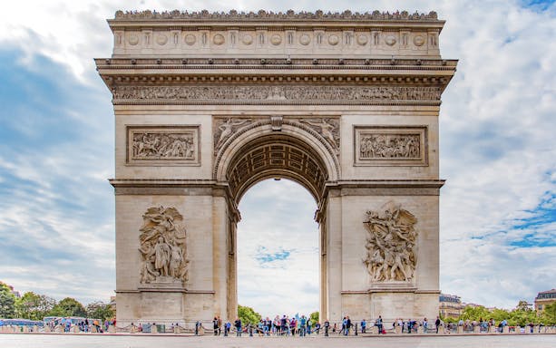 Arc de Triomphe in Paris with tourists and Big Bus in the background.