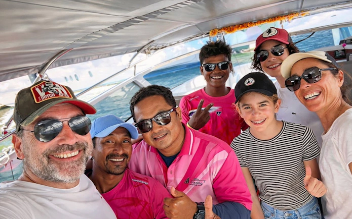Group enjoying James Bond Island speedboat tour from Phuket, smiling on deck.