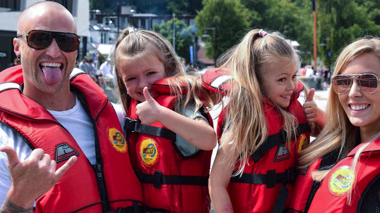 Family in life jackets enjoying a boat tour on Kawarau and Shotover Rivers.