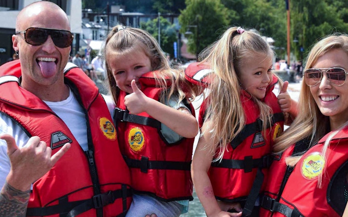 Family in life jackets enjoying a boat tour on Kawarau and Shotover Rivers.
