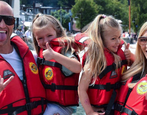 Family in life jackets enjoying a boat tour on Kawarau and Shotover Rivers.
