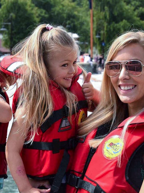 Family in life jackets enjoying a boat tour on Kawarau and Shotover Rivers.