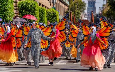 Participants in butterfly costumes at Day of the Dead parade, Mexico.