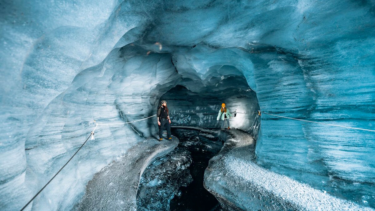 Guests exploring the icy interior of Katla Ice Cave in Iceland.
