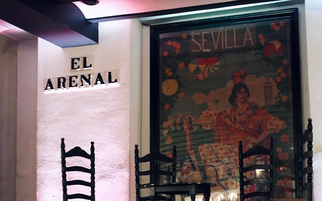 Tablao El Arenal entrance with flamenco poster in Seville.