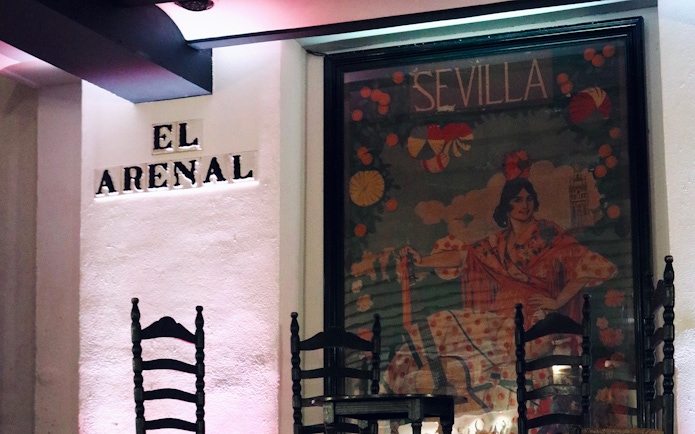 Tablao El Arenal entrance with flamenco poster in Seville.