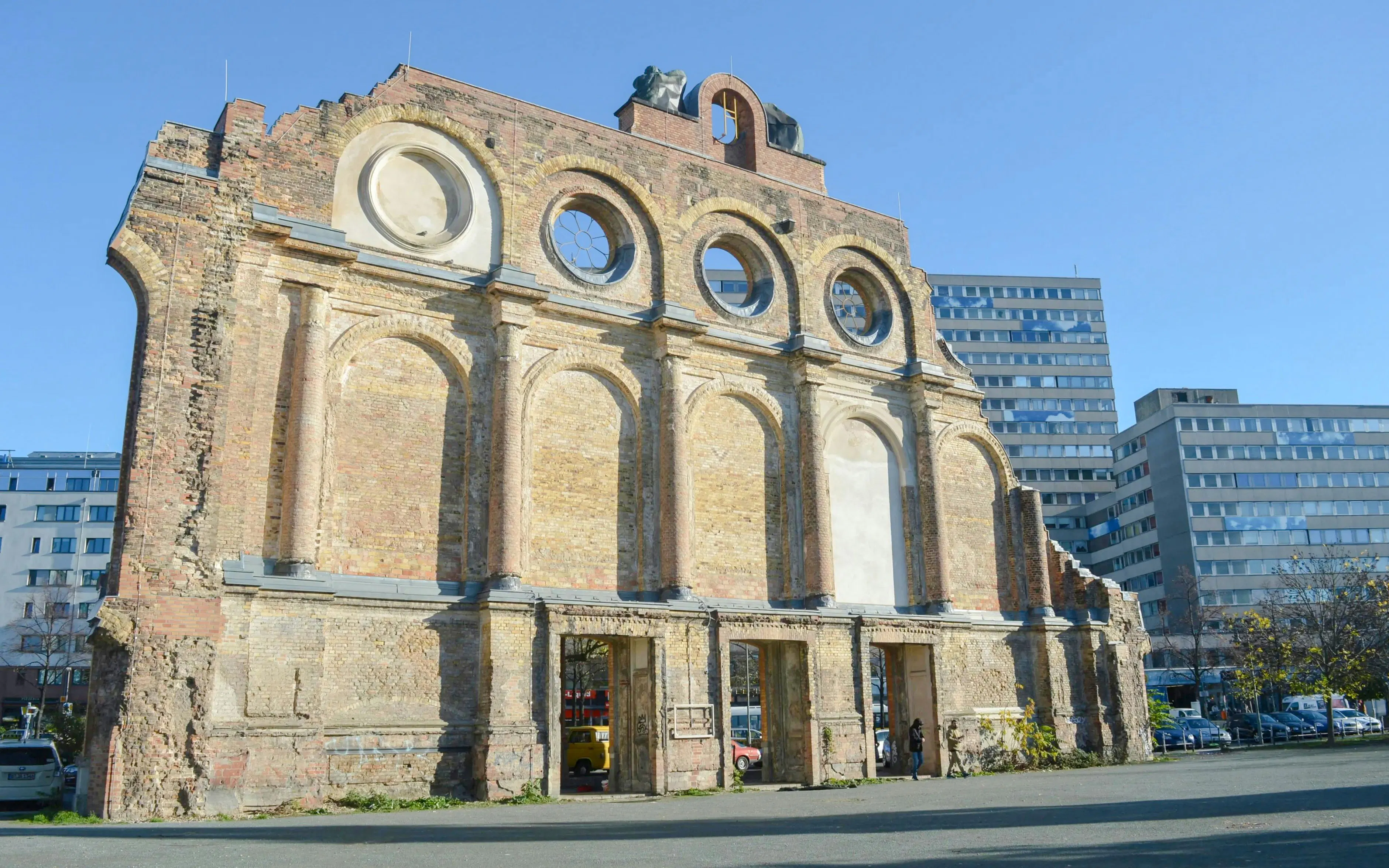 Ruins of Anhalter Bahnhof facade in Berlin with modern buildings in the background.