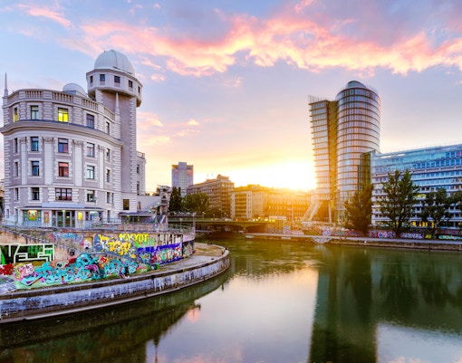 Urania observatory on Vienna's Donaukanal during evening sightseeing cruise.