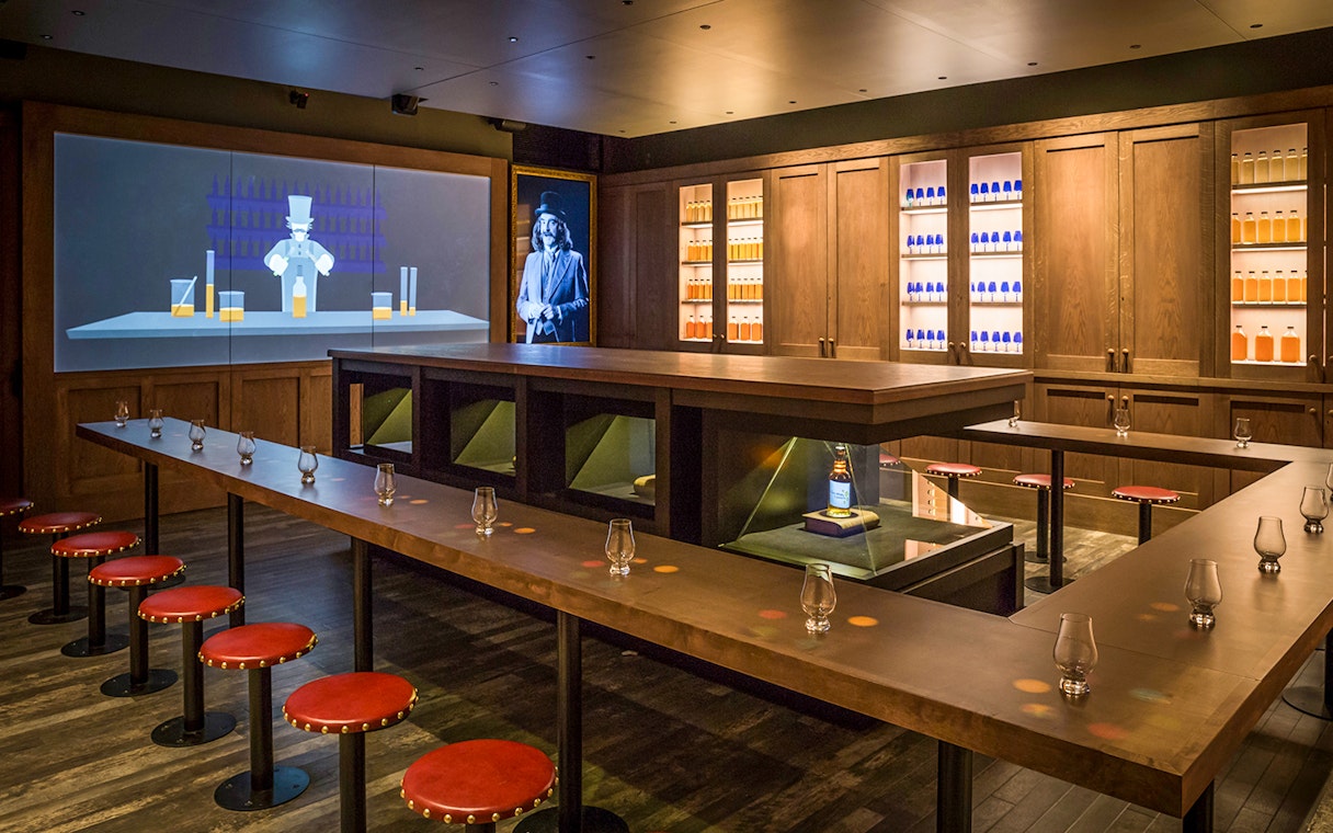 Tasting room setup at the Scotch Whisky Experience Gold Tour with glasses and whisky display.