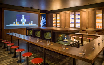 Tasting room setup at the Scotch Whisky Experience Gold Tour with glasses and whisky display.