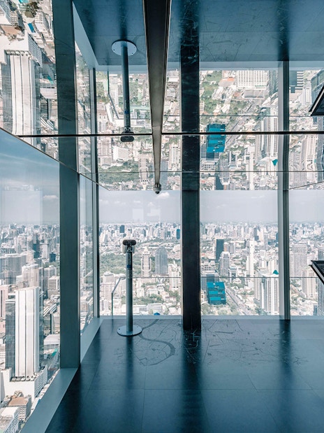 Bangkok cityscape view from Mahanakhon SkyWalk observation deck with glass floor.