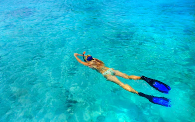 Snorkeler in clear waters of Rose Island, Green Cays, Nassau, Bahamas.