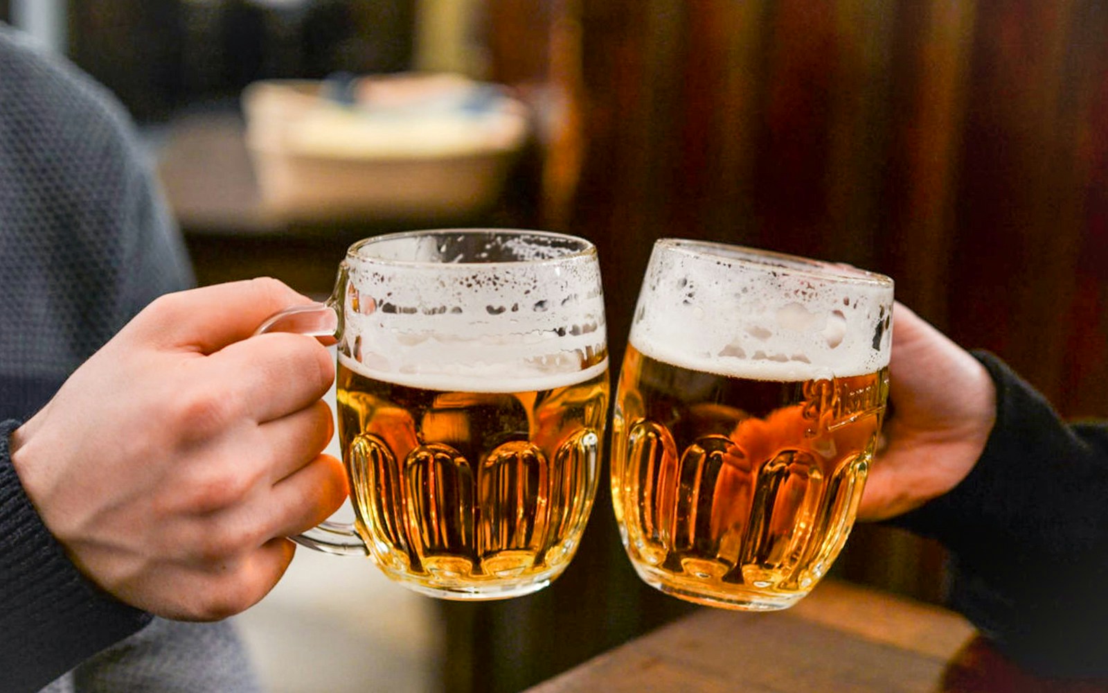 Prague river cruise with tourists enjoying unlimited beer on a scenic boat tour.