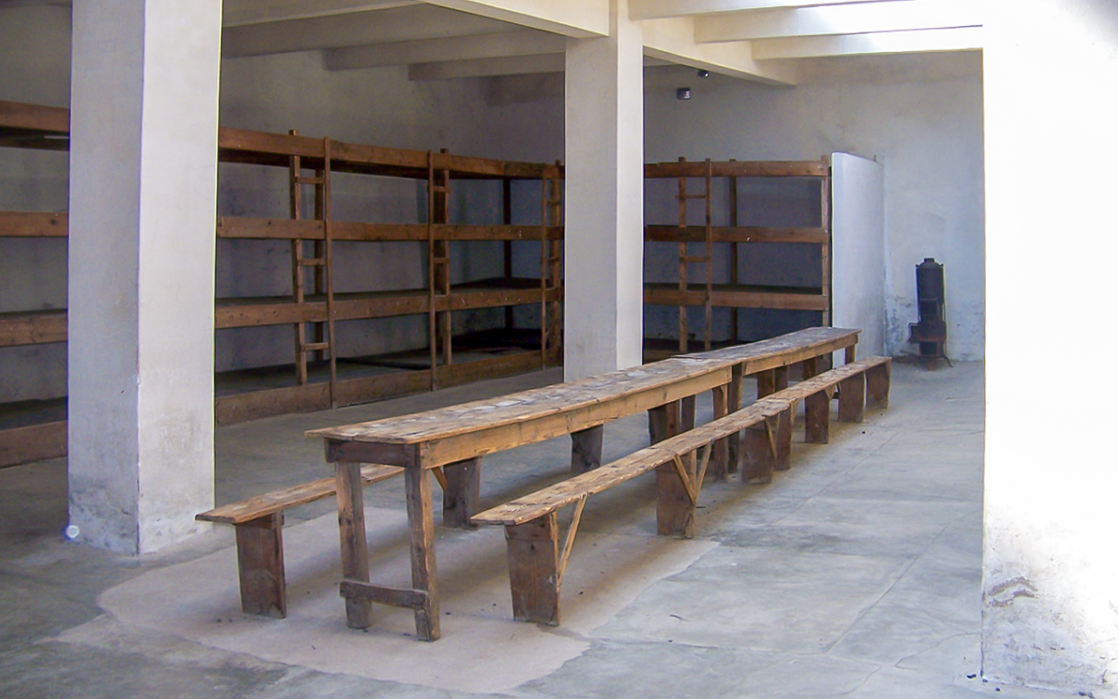 Wooden bunks and benches inside Terezin Concentration Camp.