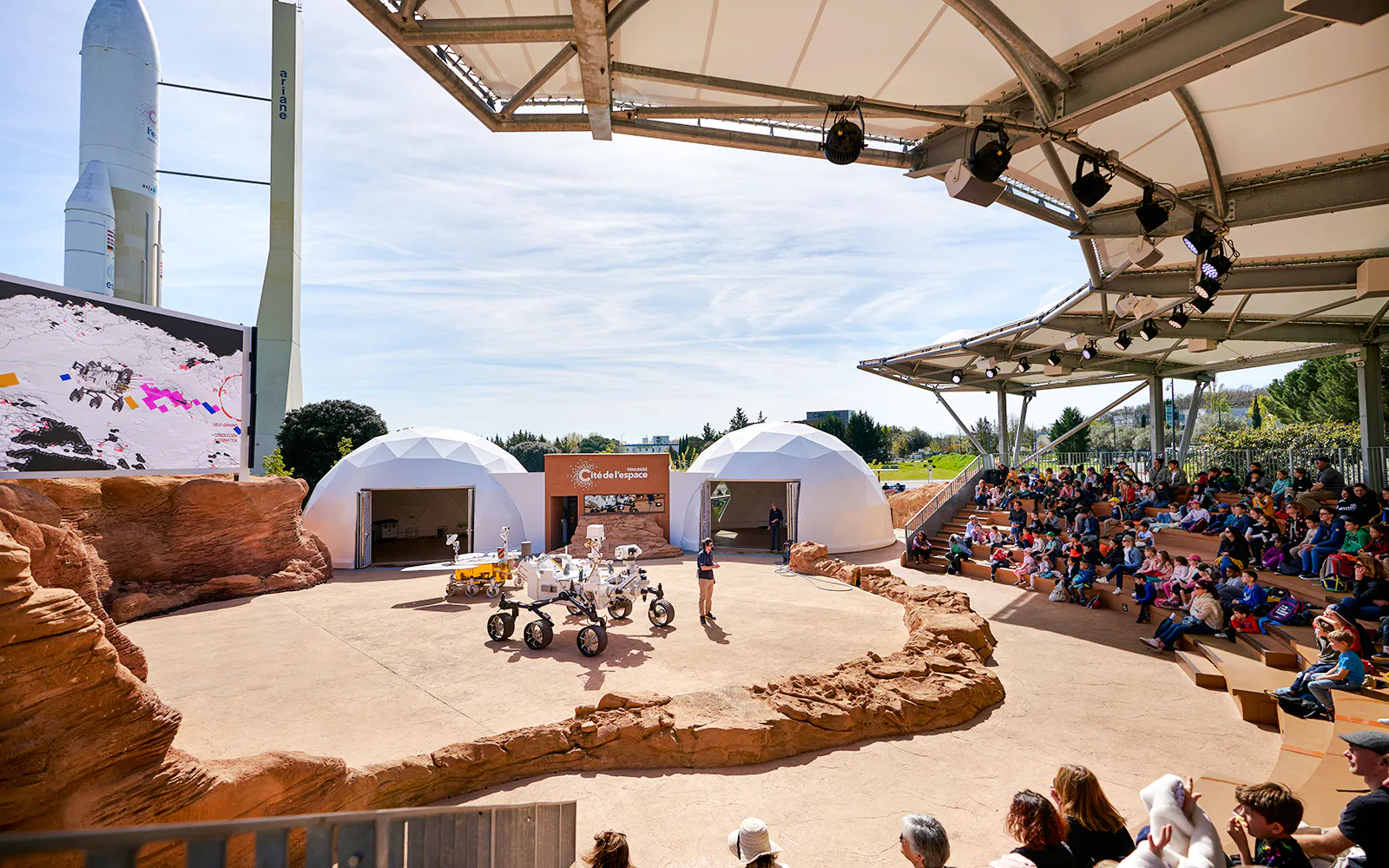 Outdoor presentation at Cité de l’Espace France with a space rover and audience.