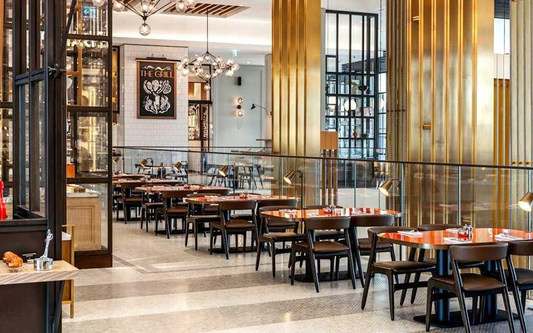 Dining area at Gastronomy, Dubai with modern decor and neatly arranged tables.