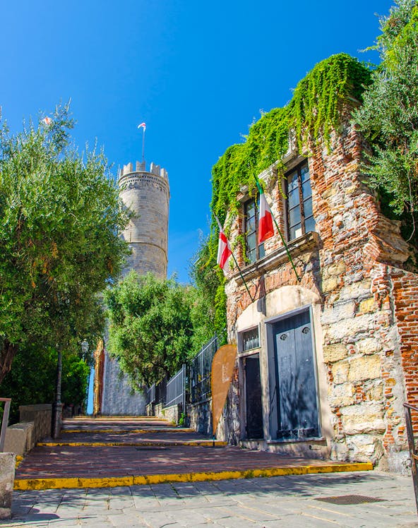 Christopher Columbus' House with ivy-covered walls and nearby tower in Genoa, Italy.