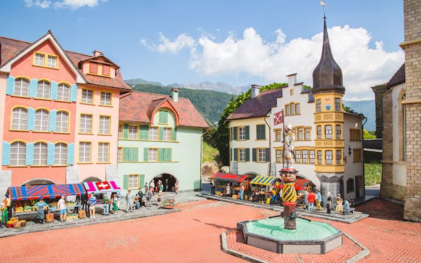 Miniature Swiss village scene with colorful buildings and market stalls at Swissminiatur.