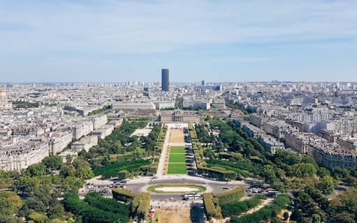 View of Paris skyline and Champ de Mars from Eiffel Tower observation deck.